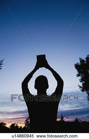 Man with Bible raised to the heavens View Large Photo Image Stock Photography - Man with Bible raised to the heavens. Fotosearch