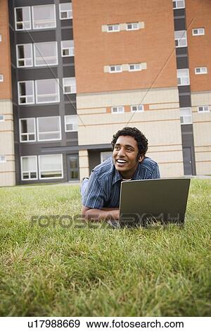 Stock Photo - Man working on a laptop. Fotosearch
