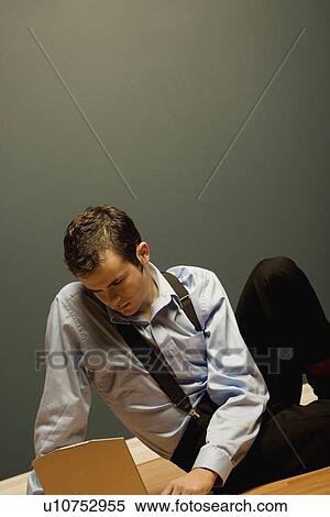 Man working on a laptop View Large Photo Image Stock Photography - Man working on a laptop. Fotosearch