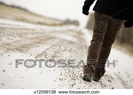 Person walking along road View Large Photo Image Stock Photo - Person walking along road. Fotosearch