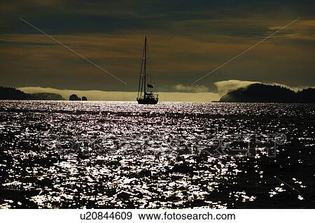 Sailboat on water at dusk View Large Photo Image Stock Photo - Sailboat on water at dusk. Fotosearch