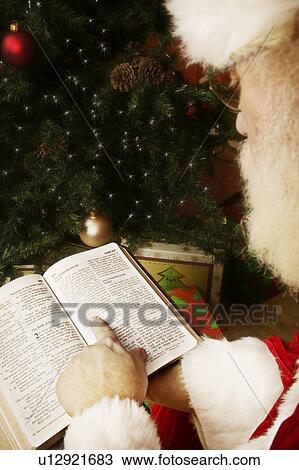 Stock Image - Santa reading the Bible. Fotosearch