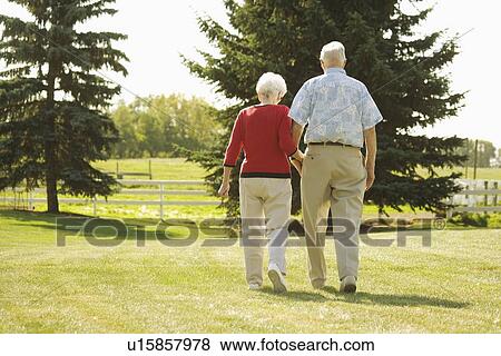 Senior couple walking hand in hand View Large Photo Image Stock Photo - Senior couple walking hand in hand. Fotosearch