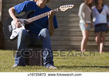 Teen playing guitar View Large Photo Image Stock Image - Teen playing guitar. Fotosearch
