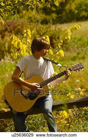 Teen playing guitar View Large Photo Image Stock Photo - Teen playing guitar. Fotosearch