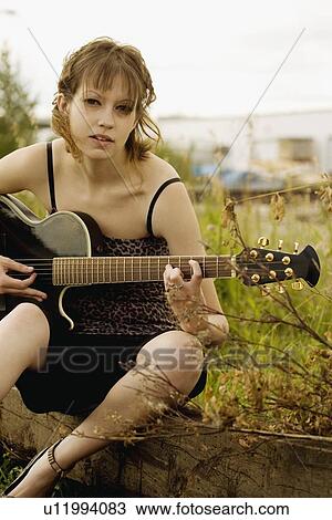 Woman playing guitar View Large Photo Image Stock Image - Woman playing guitar. Fotosearch