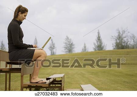 Working outside on laptop View Large Photo Image Stock Image - Working outside on laptop. Fotosearch