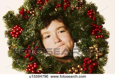 Young boy in Christmas wreath View Large Photo Image Stock Photograph - Young boy in Christmas wreath. Fotosearch