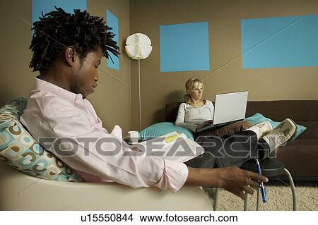Picture - Young man and woman studying. Fotosearch