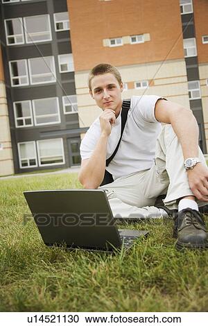 Stock Image - Young man working on computer. Fotosearch
