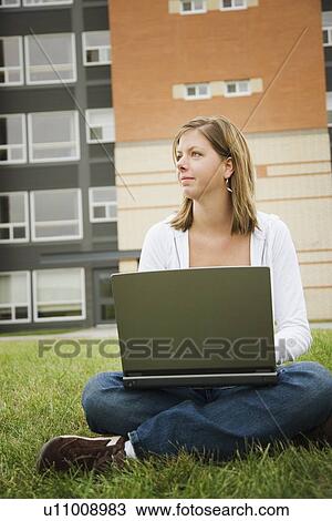 Young woman working on laptop View Large Photo Image Stock Image - Young woman working on laptop. Fotosearch