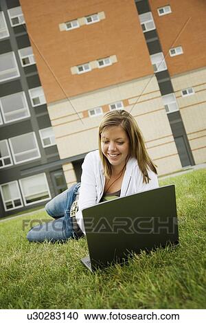 Young woman working on laptop View Large Photo Image Stock Image - Young woman working on laptop. Fotosearch