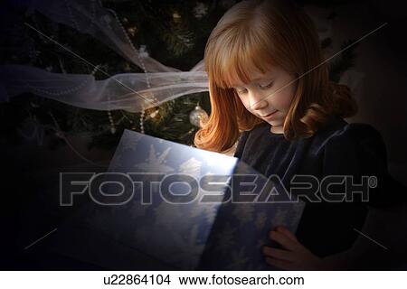 Child looking inside Christmas present View Large Photo Image Picture - Child looking inside Christmas present. Fotosearch