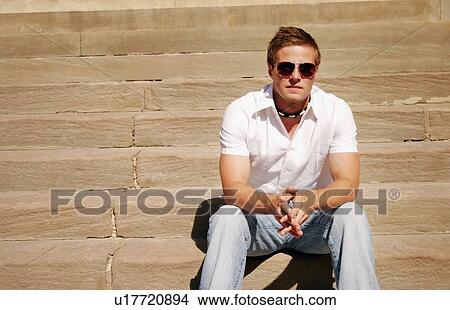 Picture - Guy sitting on steps. Fotosearch