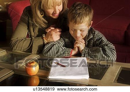 Mother and son praying together View Large Photo Image Stock Photo - Mother and son praying together. Fotosearch