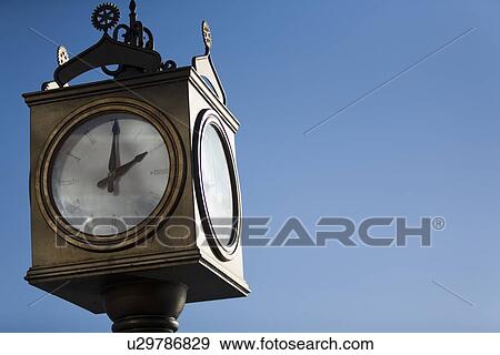 Old-fashioned outdoor clock View Large Photo Image Stock Photo - Old-fashioned outdoor clock. Fotosearch