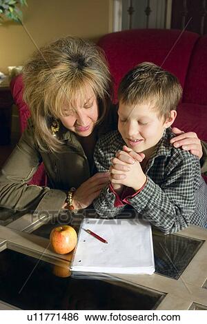 Stock Photograph - Praying together. Fotosearch