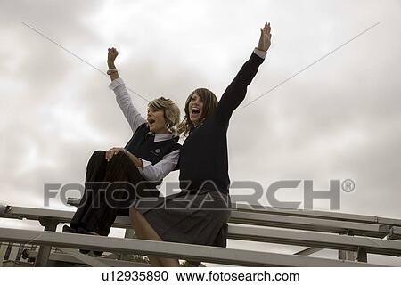 Stock Image - Two fans cheering. Fotosearch