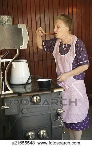 A woman sampling food View Large Photo Image Stock Photo - A woman sampling food . Fotosearch
