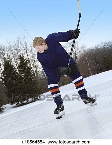 Picture - Boy ready for slap shot. Fotosearch
