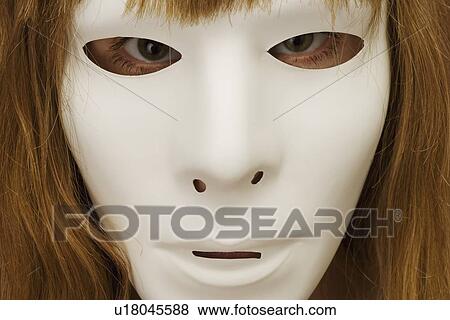 Woman hiding behind mask View Large Photo Image Stock Photo - Woman hiding behind mask. Fotosearch