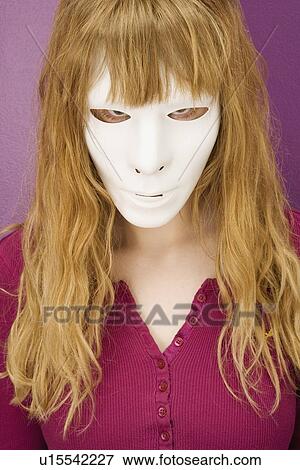 Woman peering angrily behind mask View Large Photo Image Stock Photo - Woman peering angrily behind mask. Fotosearch
