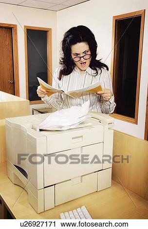 Stock Image - Woman reading instructions. Fotosearch