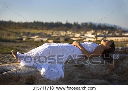 A Filipino woman wearing a white dress on the beach View Large Photo Image Stock Photo - A Filipino woman wearing a white dress on the beach. Fotosearch