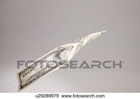 Stock Photo - A one hundred dollar bill floating through the air. Fotosearch