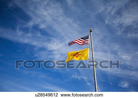 Stock Image - American flag and New Mexico flag on flag pole . Fotosearch