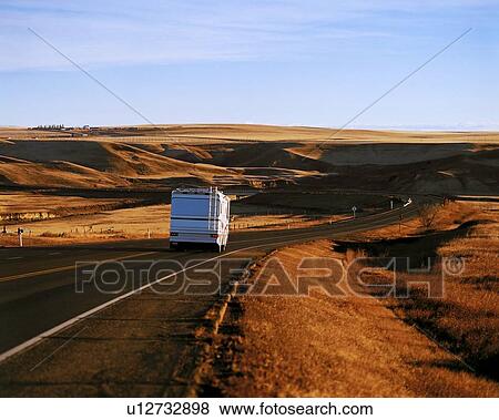 An RV travelling down the hiway View Large Photo Image Stock Photo - An RV travelling down the hiway. Fotosearch