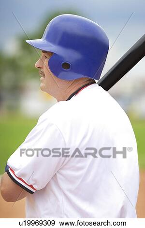 Baseball player holding bat, ready to hit View Large Photo Image Stock Photo - Baseball player holding bat, ready to hit. Fotosearch