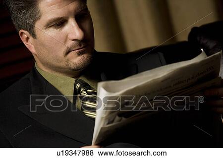 Businessman reading the paper View Large Photo Image Stock Photo - Businessman reading the paper. Fotosearch
