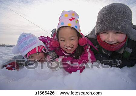 Stock Image - Children playing in the snow. Fotosearch