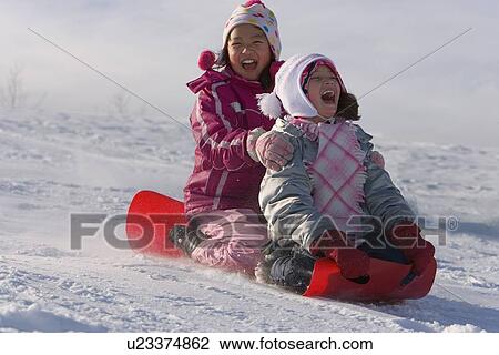 Stock Image - Children tobogganing. Fotosearch