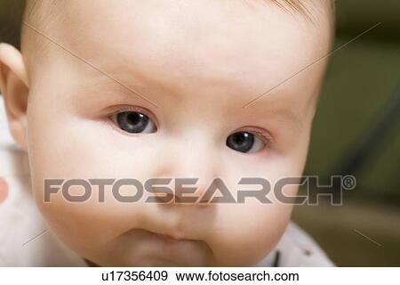 Stock Photo - Close up of baby face. Fotosearch