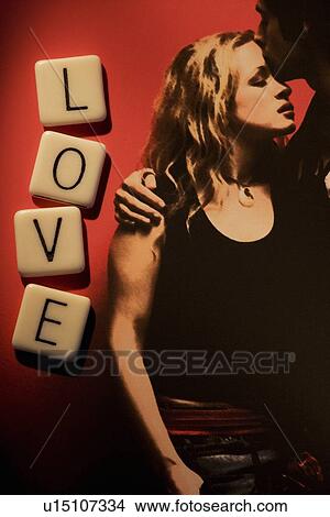 Picture - Couple embracing with word "love". Fotosearch