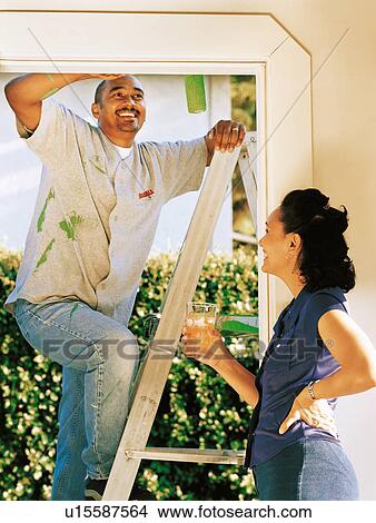 Couple painting doorway View Large Photo Image Picture - Couple painting doorway. Fotosearch