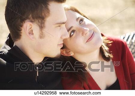 Couple sitting together View Large Photo Image Stock Photo - Couple sitting together. Fotosearch