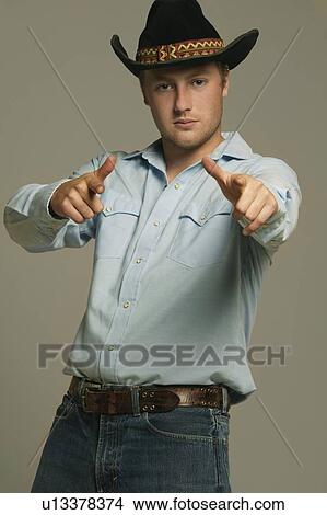Cowboy pointing with two hands ahead View Large Photo Image Picture - Cowboy pointing with two hands ahead. Fotosearch