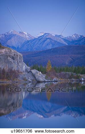 Stock Photograph - Fall evening mountain reflection in water . Fotosearch
