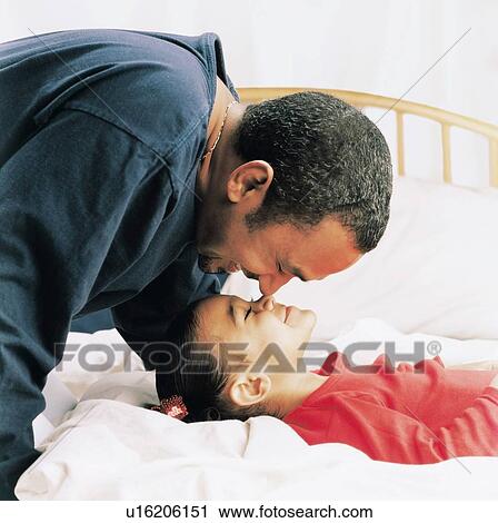 Stock Image - Father and daughter being affectionate. Fotosearch