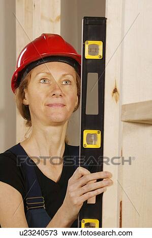 Female construction worker using a level View Large Photo Image Stock Image - Female construction worker using a level. Fotosearch