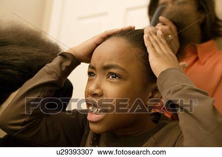 Girl having hair done View Large Photo Image Stock Photo - Girl having hair done . Fotosearch