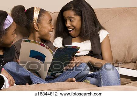 Girls excited about books View Large Photo Image Stock Image - Girls excited about books. Fotosearch