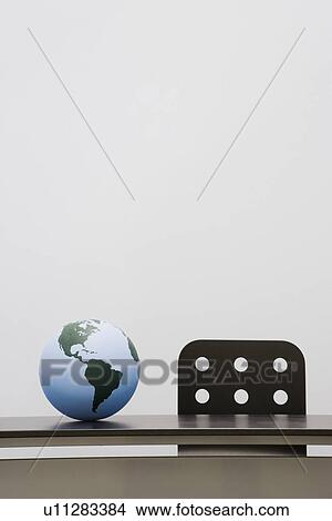 Picture - Globe on a desk. Fotosearch