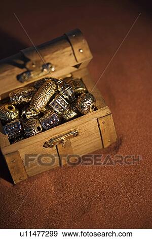 Golden beads in a box View Large Photo Image Stock Photo - Golden beads in a box. Fotosearch