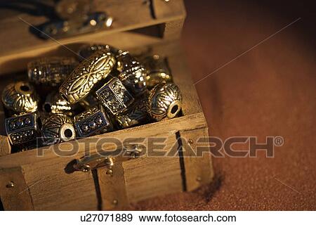 Stock Photo - Golden beads in a box. Fotosearch