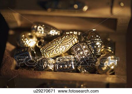 Stock Image - Golden beads in box. Fotosearch
