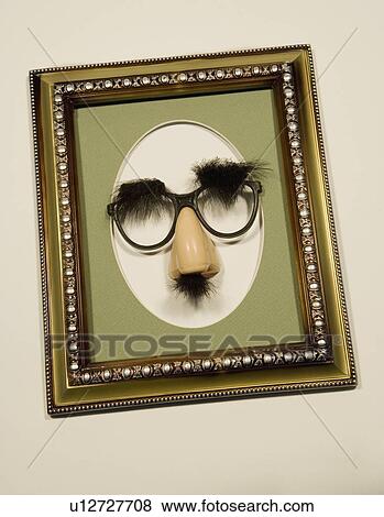 Stock Photo - Groucho glasses in a picture frame. Fotosearch